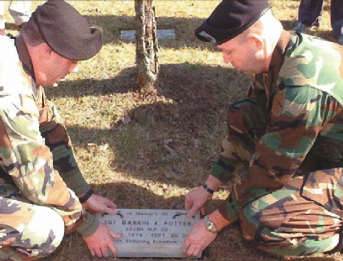 soldiers place potter memorial stone